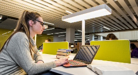 Student reading a reference book